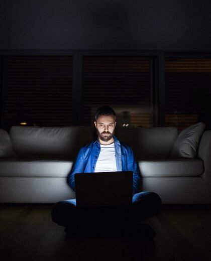 a-man-working-on-a-laptop-at-home-at-night- a-man-working-on-a-laptop-at-home-at-night-